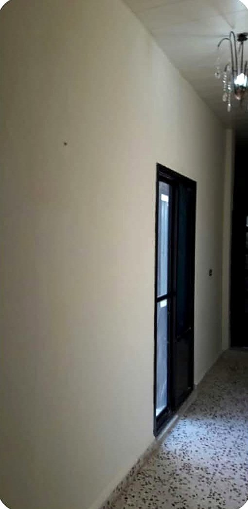 Hallway after skim coating and repainting by DDP, smooth and bright
