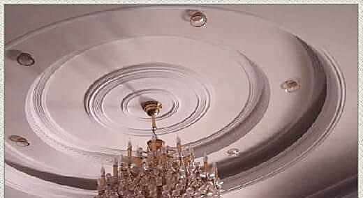Restored decorative plaster ceiling medallion with chandelier