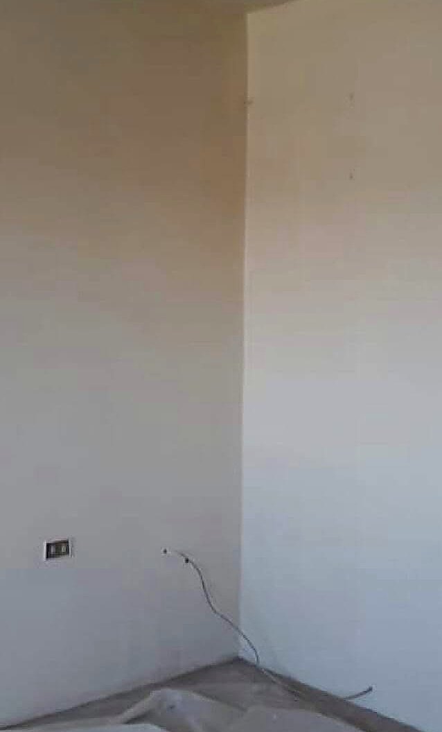 Living room with a dark painted feature wall and ceiling